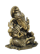 A small brass Lord Ganesha idol, seated and holding a trident, 